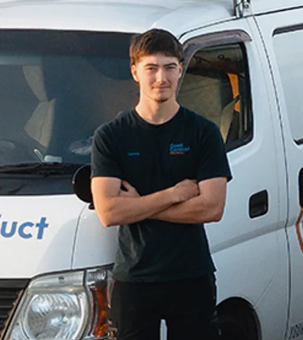Tomas Clark, first-year apprentice, in front of a Good Conduct van