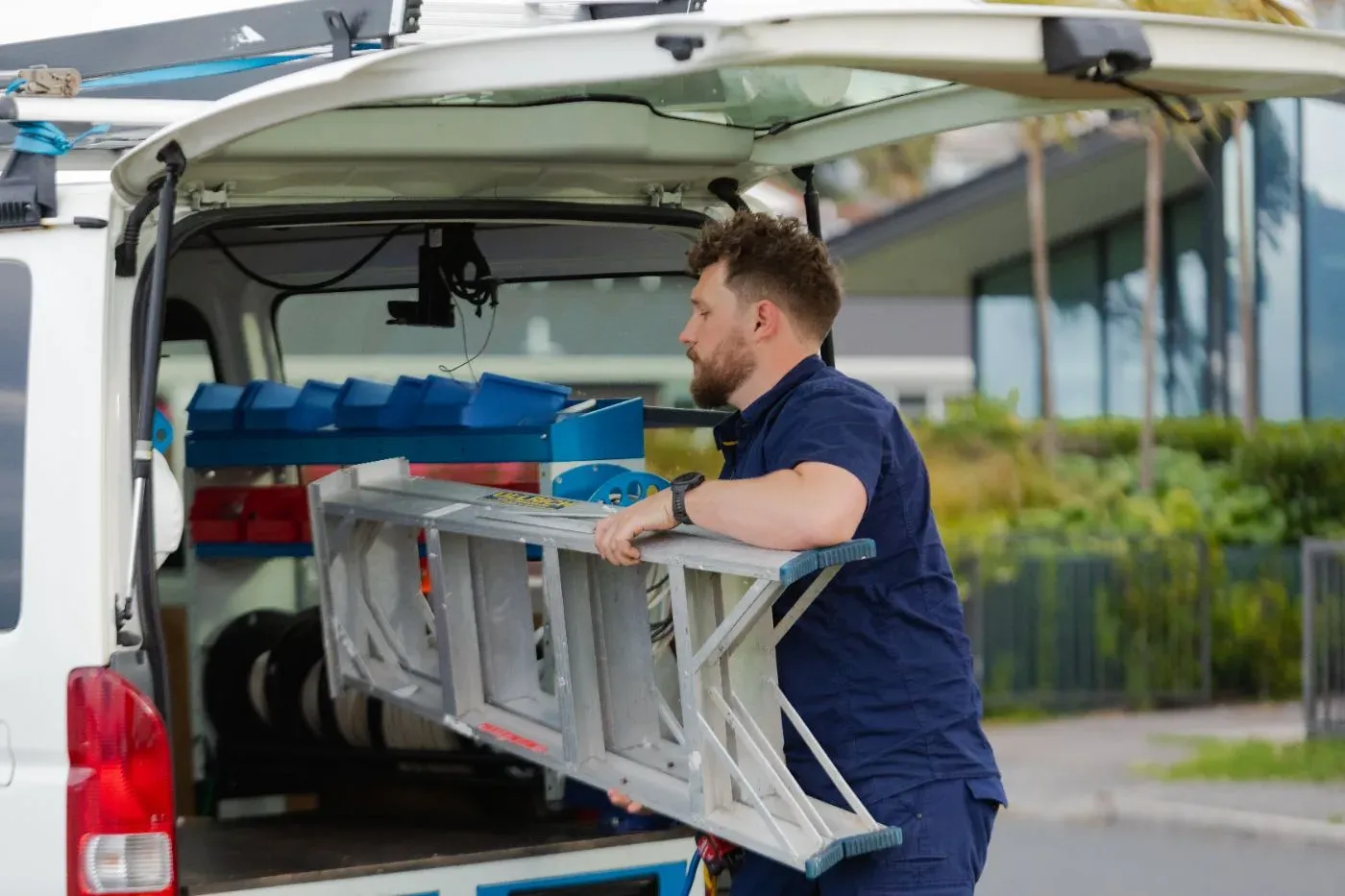 Unloading a ladder from the van