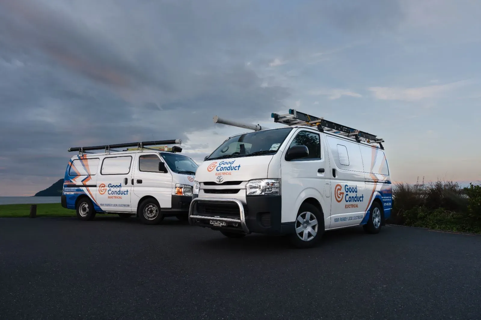 Two Good Conduct Electrical vans at dusk